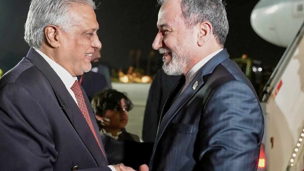 Pakistan’s Foreign Minister Ishaq Dar (L) greeting his Iranian counterpart Abbas Araghchi upon his arrival in Islamabad 