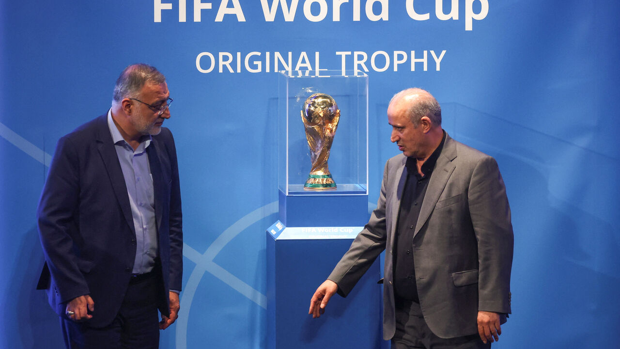 FILE PHOTO: President of Iran Football Federation Mehdi Taj and Mayor of Tehran Alireza Zakani stand next to the FIFA World Cup Trophy during an unveiling ceremony in Tehran, Iran September 1, 2022.  Majid Asgaripour/WANA (West Asia News Agency) via REUTERS/ File Photo