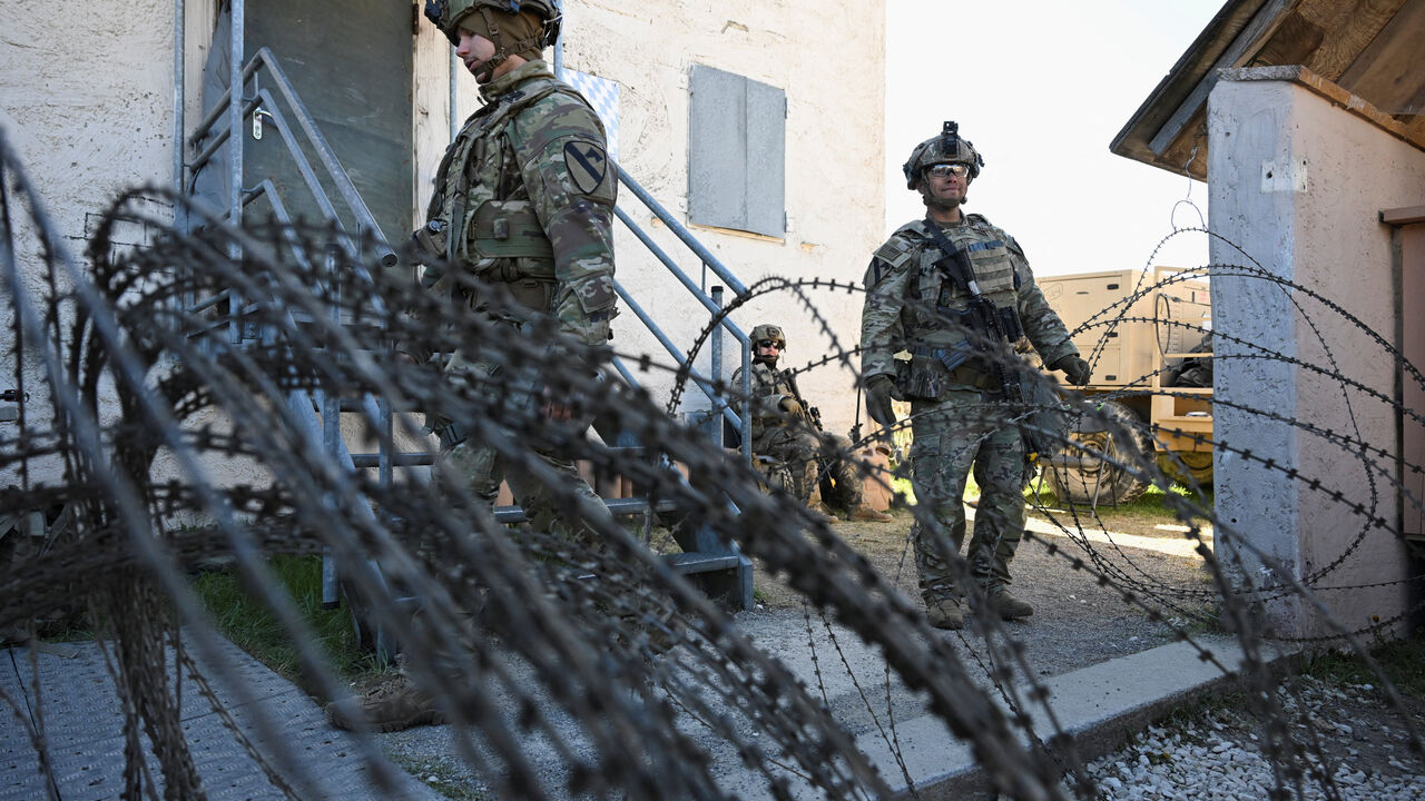 Soldiers stand next to a razor wire at a media day during the U.S. Army Combined Resolve exercise at the U.S. Army's southern Germany training facilities in Hohenfels, Germany, April 30, 2026. REUTERS/Angelika Warmuth