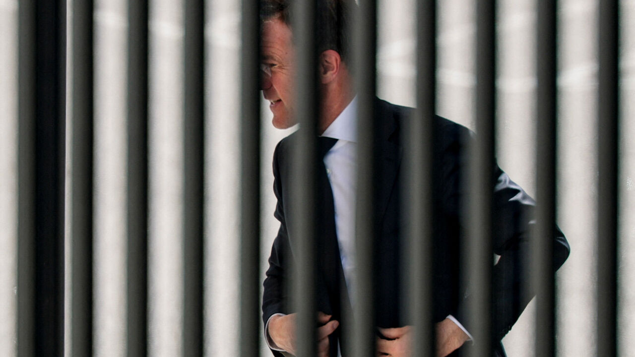 NATO Secretary General Mark Rutte walks into the White House, as seen through a fence, in Washington, D.C., U.S., April 8, 2026. REUTERS/Evan Vucci