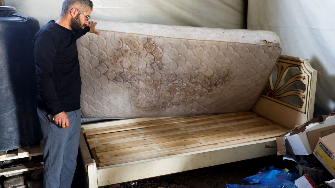 A Palestinian man looks at a wooden bed, amid shortages of materials, in Khan Younis, in the southern Gaza Strip, May 2, 2026. REUTERS/Haseeb Alwazeer