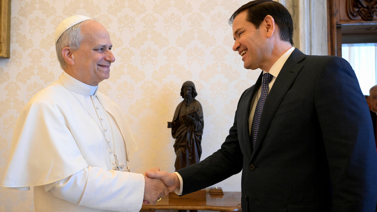 FILE PHOTO: Pope Leo XIV shakes hands with U.S. Secretary of State Marco Rubio as they meet at the Vatican, May 19, 2025. Vatican Media/­Simone Risoluti/Handout via REUTERS/ File Photo