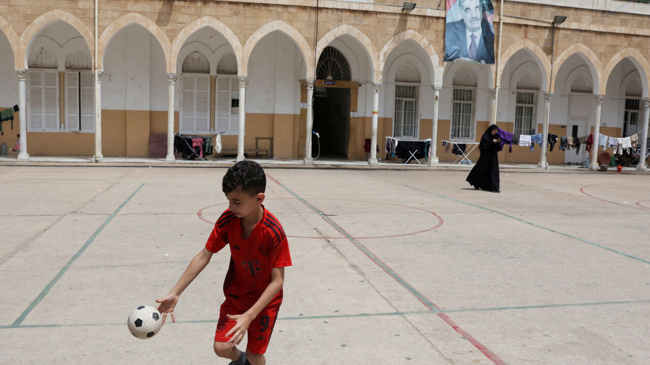 FILE PHOTO: A child plays in the yard of Hariri High School II, used as a temporary shelter for displaced people, in Beirut, Lebanon, May 2, 2026. REUTERS/ Raghed Waked/File Photo