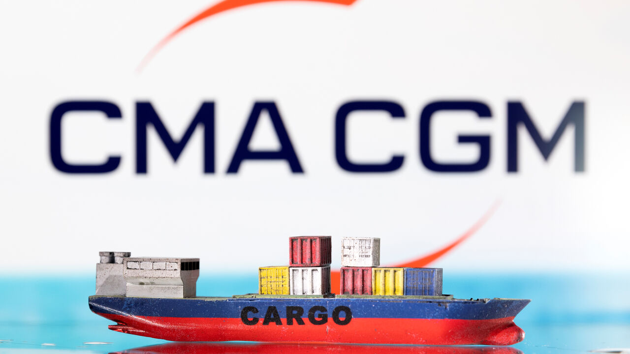 A cargo ship boat model is pictured in front of the CMA CGM logo in this illustration taken March 3, 2022. REUTERS/Dado Ruvic/Illustration