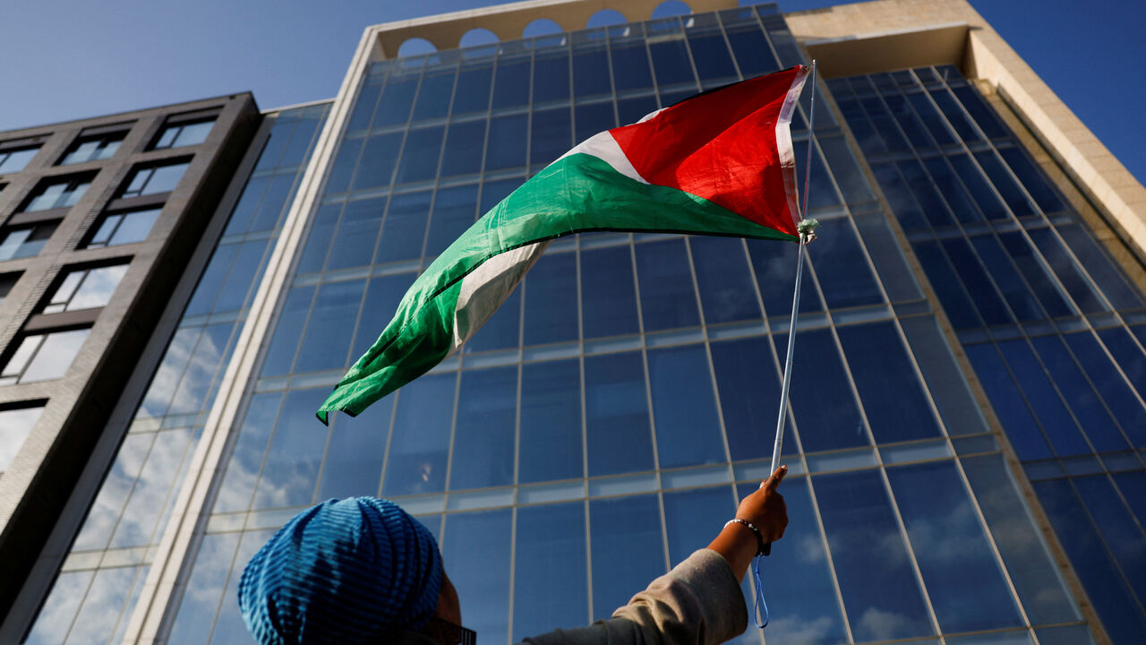 A demonstrator waves a Palestinian flag, during a protest against the U.S. backing of the Israeli military operation in Gaza, outside the Washington office of the American Israel Public Affairs Committee (AIPAC) in Washington, D.C., U.S., September 22, 2025. REUTERS/Daniel Becerril/ File Photo