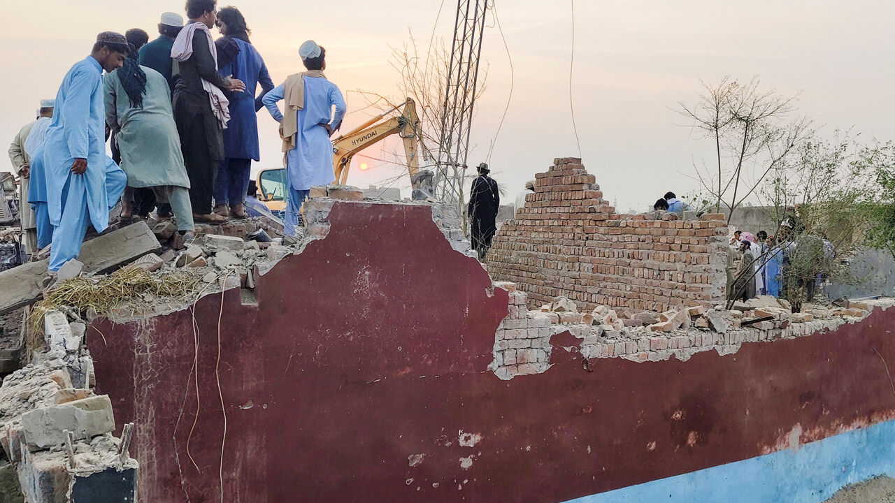 Residents gather on the rubble of a damaged police post after a car bombing in Bannu, Khyber Pakhtunkhwa province, Pakistan May 10, 2026. Picture taken with a mobile phone. REUTERS/Ehsan Khattak