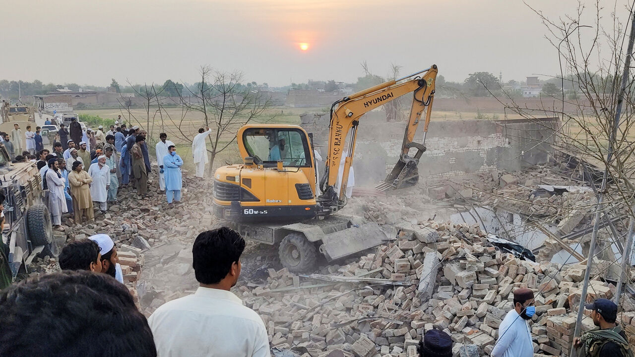 Residents gather as heavy machinery clears the rubble of a damaged police post after a car bombing in Bannu, Khyber Pakhtunkhwa province, Pakistan May 10, 2026. Picture taken with a mobile phone. REUTERS/Ehsan Khattak
