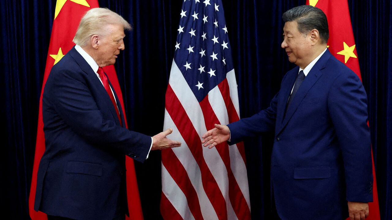 FILE PHOTO: U.S. President Donald Trump shakes hands with Chinese President Xi Jinping as they hold a bilateral meeting at Gimhae International Airport, on the sidelines of the Asia-Pacific Economic Cooperation (APEC) summit, in Busan, South Korea, October 30, 2025. REUTERS/Evelyn Hockstein//File Photo