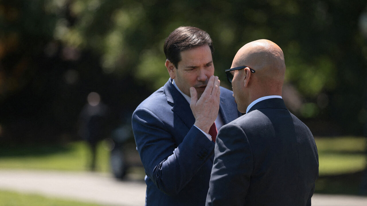 U.S. Secretary of State Marco Rubio talks with White House Director of Oval Office Operations Walt Nauta, ahead of U.S. President Donald Trump's departure from the White House for Joint Base Andrews en route to Beijing, China, in Washington, D.C., U.S., May 12, 2026. REUTERS/Evelyn Hockstein