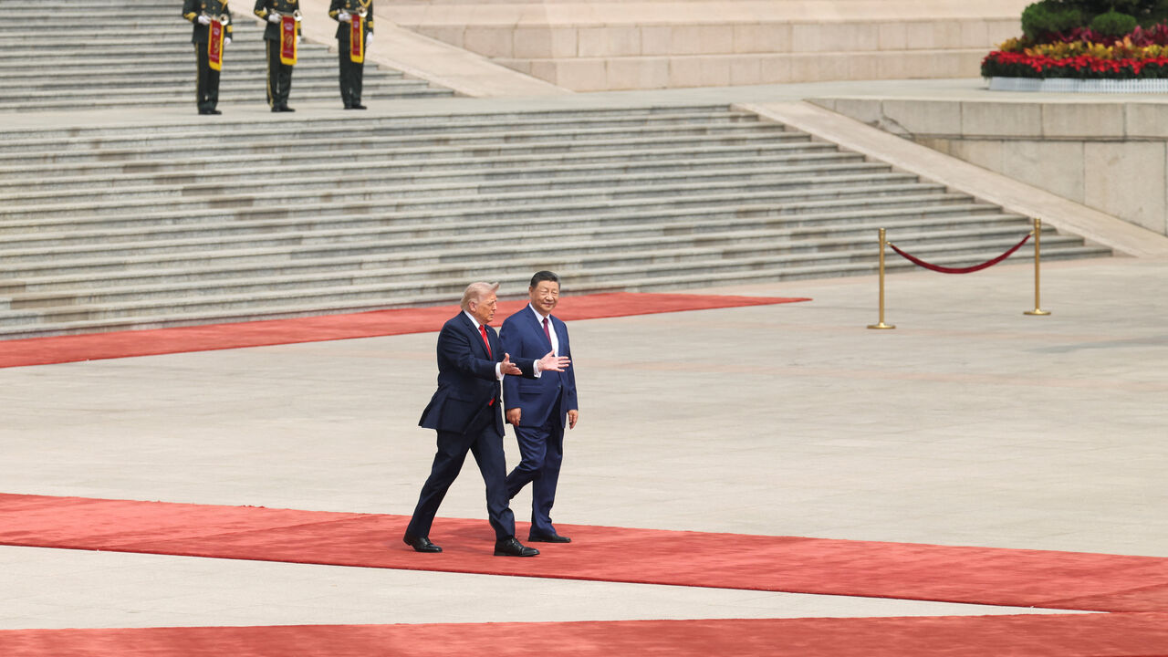 Chinese President Xi Jinping walks with U.S. President Donald Trump during a welcome ceremony at the Great Hall of the People, in Beijing, China, May 14, 2026. REUTERS/Maxim Shemetov/Pool