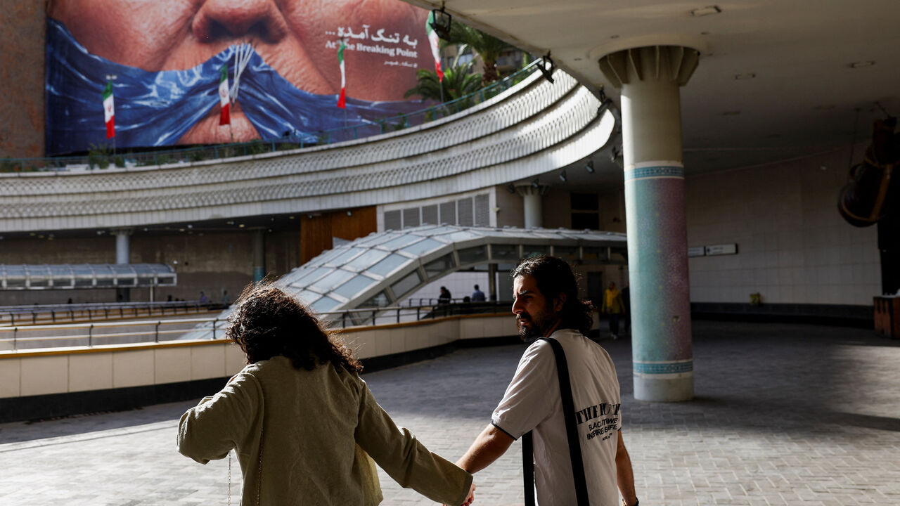 People walk past an anti-U.S. billboard depicting U.S. President Donald Trump and the Strait of Hormuz, in Tehran, Iran, May 17, 2026. Majid Asgaripour/WANA (West Asia News Agency) via REUTERS ATTENTION EDITORS - THIS PICTURE WAS PROVIDED BY A THIRD PARTY