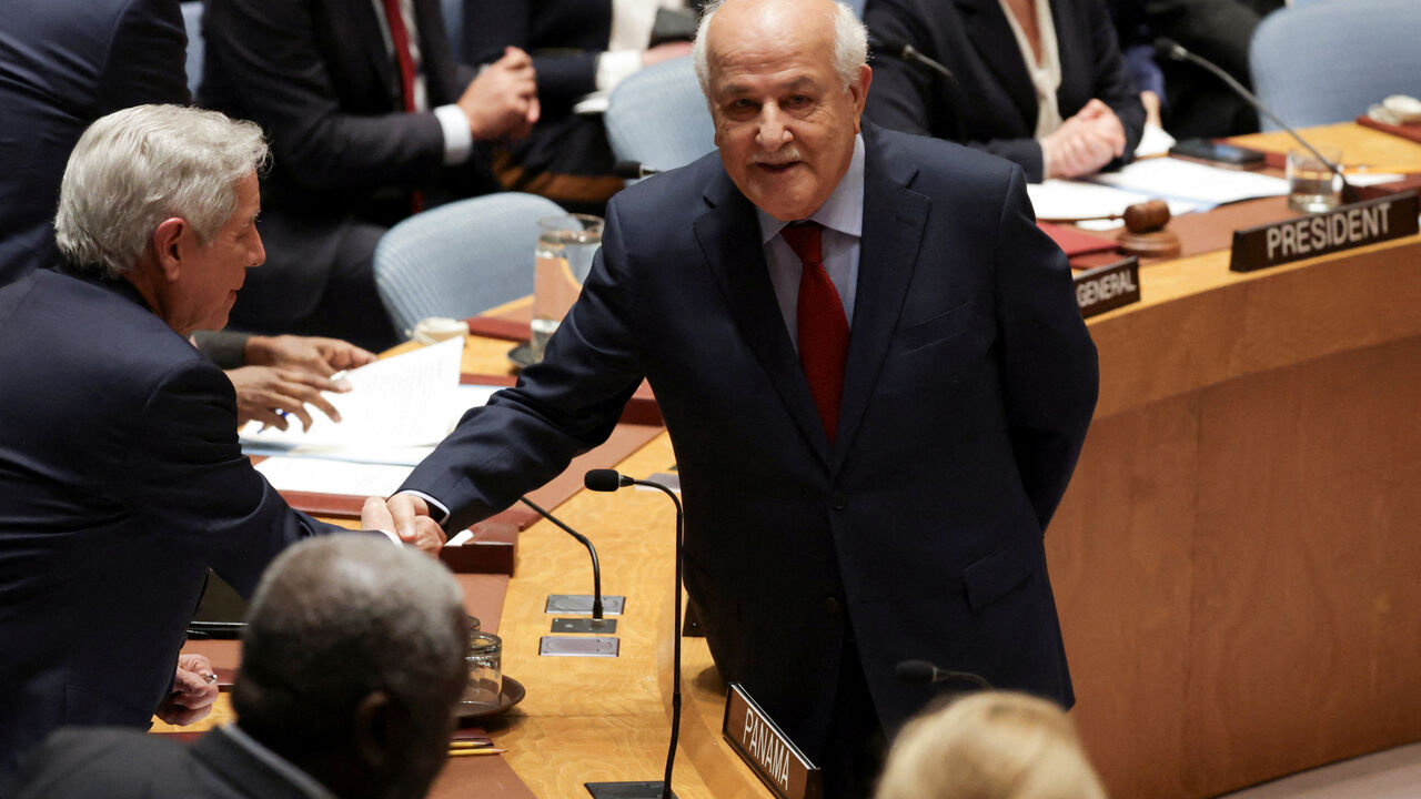 FILE PHOTO: Riyad H. Mansour, Palestinian Permanent Observer to the United Nations, shakes hands with Eloy Alfaro de Alba, Permanent Representative of Panama to the UN, before a Security Council meeting on the situation in the Middle East, at U.N. headquarters in New York City, U.S., February 18, 2026. REUTERS/Jeenah Moon/File Photo