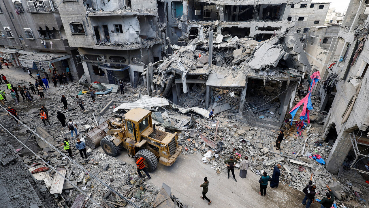 Palestinians gather at the site of an Israeli strike on a house that was pre-warned by the Israeli military to evacuate before the strike was carried out late on Wednesday, in Al-Maghazi refugee camp, in the central Gaza Strip, May 21, 2026. REUTERS/Mahmoud Issa/File Photo
