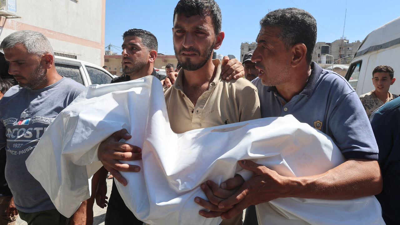 A mourner carries the body of six-year-old Palestinian girl Mennatallah Abu Libda, who was killed in an Israeli strike on a tent encampment for displaced families, according to medics, in Khan Younis in the southern Gaza Strip May 25, 2026. REUTERS/Ramadan Abed