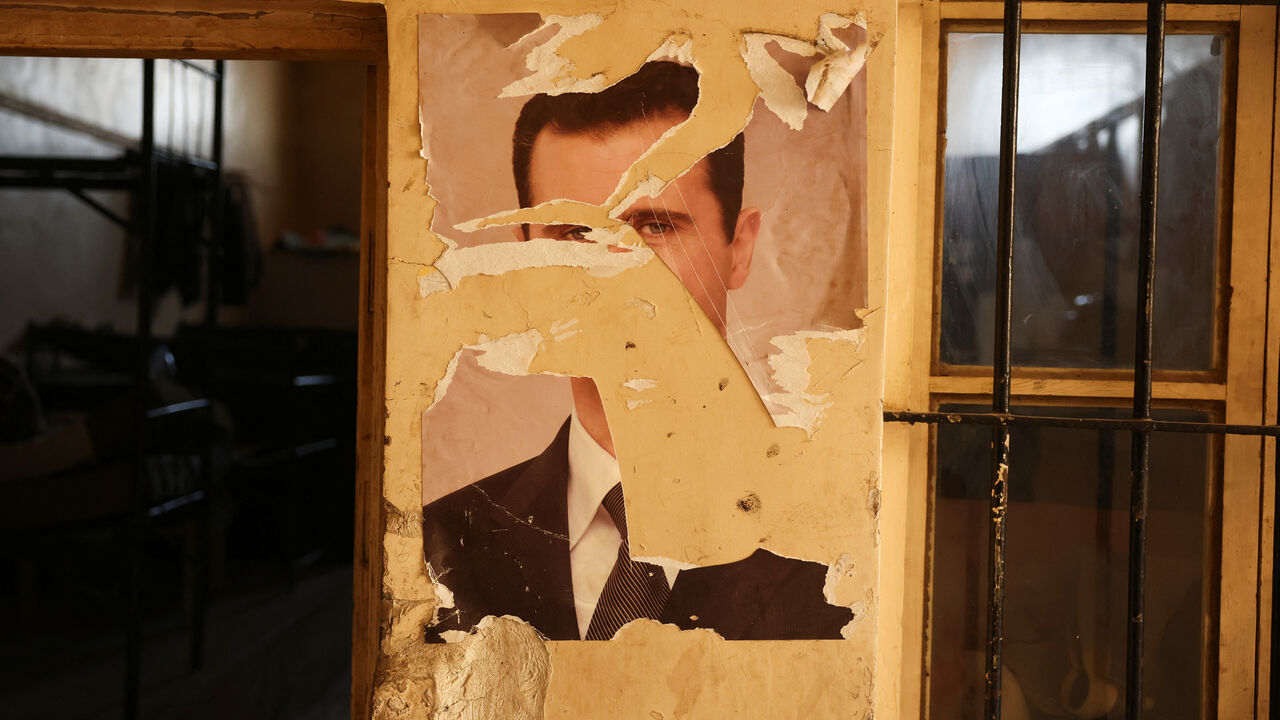 A damaged portrait of former Syrian President Bashar al-Assad at a military base in Damascus, Syria, December 15, 2024. REUTERS/Amr Alfiky