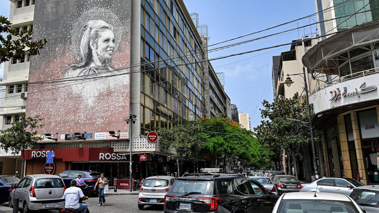 Vehicles move past a giant mural on the side of a building showing an image of the late Lebanese actress and singer Sabah (1927-2014) along Beirut's Hamra street on June 20, 2024. 