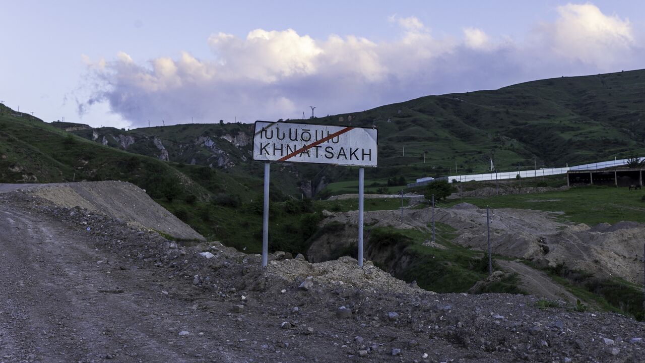 A roadside sign marks the entrance to Khnatsakh on May 16, 2025, a border village in Armenia's Syunik Province that has become a frontline community amid rising tensions with Azerbaijan. 