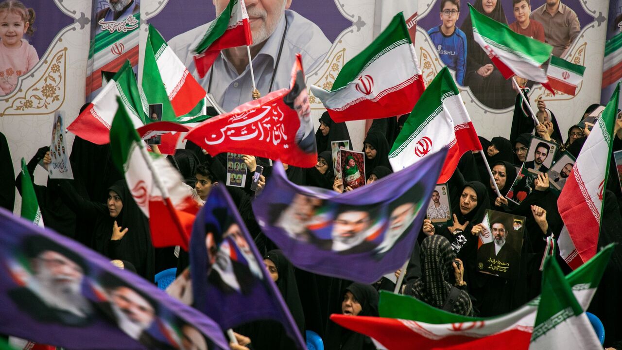 People hold portraits of the dead at the Imam Khomeini Mosalla Mosque to commemorate those killed in the current US-Israeli war as well as previous wars on May 24, 2026, in Tehran, Iran.