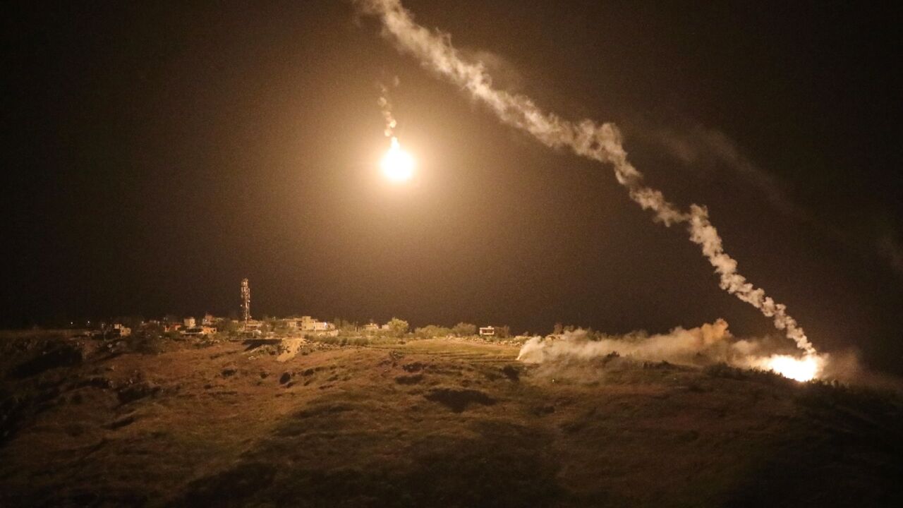 A photograph taken from the southern area of Marjayoun shows flares fired by the Israeli military descending over the village of Arnoun late on May 13, 2026