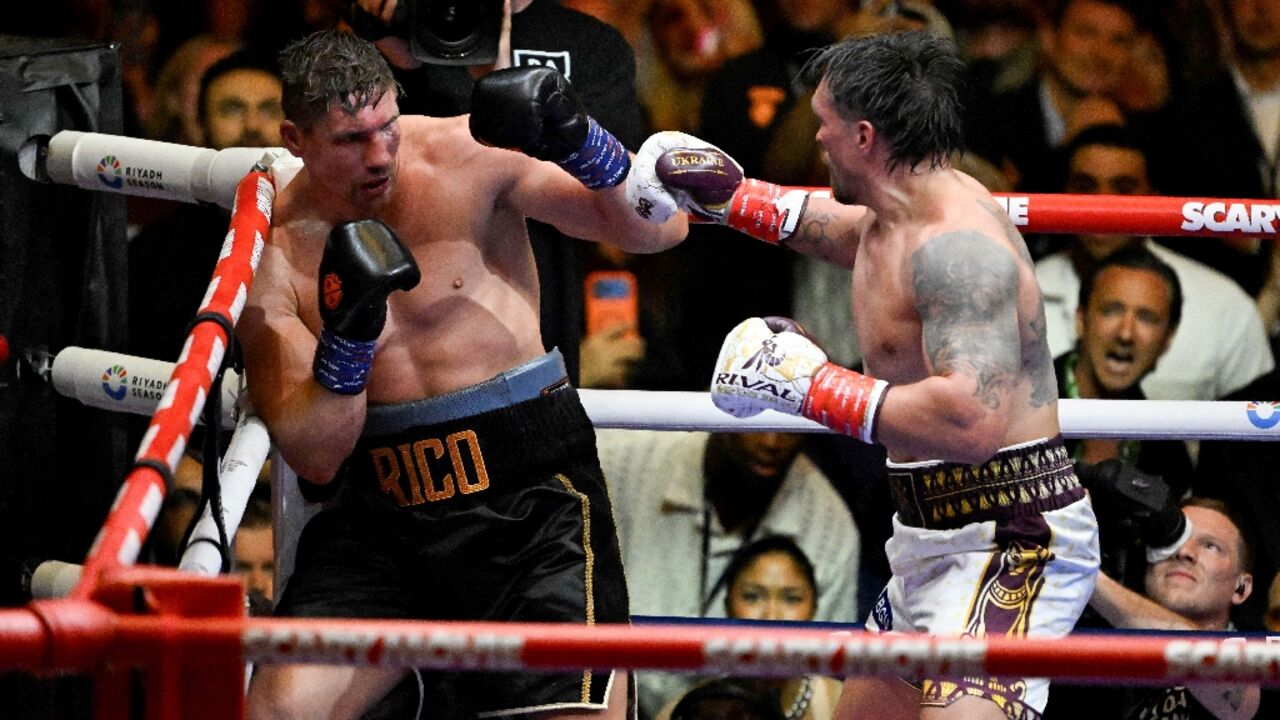 Ukraine's Oleksandr Usyk (right) throws a flurry of punches at Netherlands' Rico Verhoeven (left) on his way to retaining his WBA, WBC and IBF heavyweight belts in Egypt