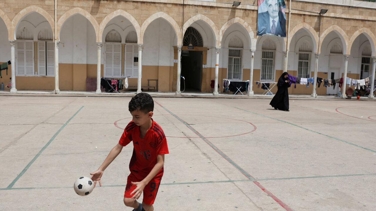 A child plays in the yard of a school used as a temporary shelter for displaced people, in Beirut, Lebanon, May 2, 2026. REUTERS/ Raghed Waked