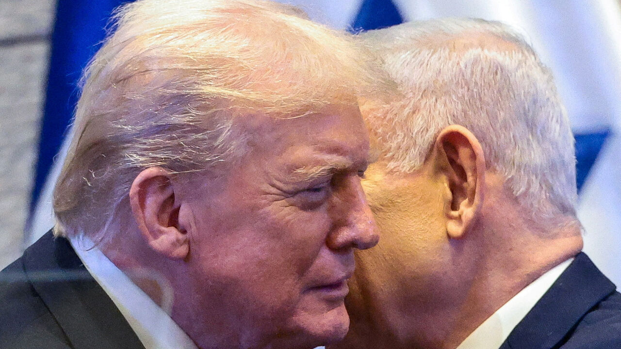 FILE PHOTO: U.S. President Donald Trump and Israeli Prime Minister Benjamin Netanyahu at the Knesset on the day of Trump's address, amid a U.S.-brokered prisoner-hostage swap and ceasefire deal between Israel and Hamas, in Jerusalem, October 13, 2025. REUTERS/Evelyn Hockstein/Pool/File Photo