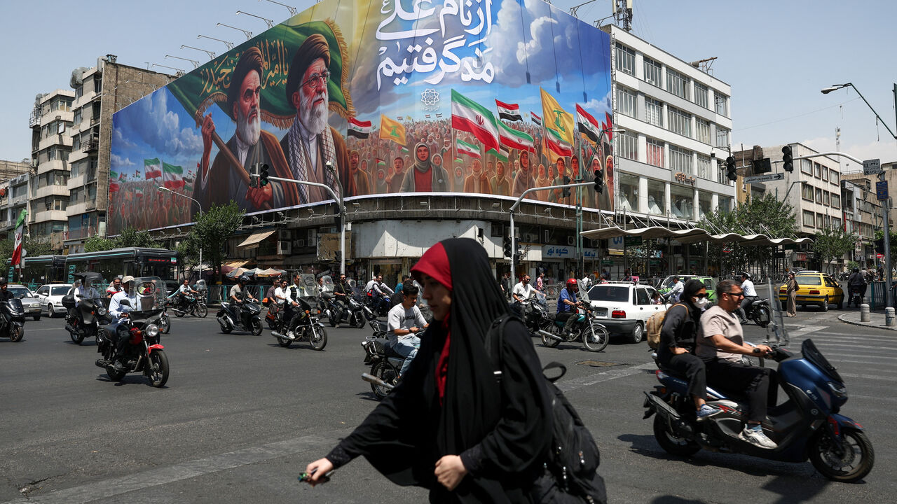 People ride past a billboard depicting the late leader of the Islamic Revolution, Ayatollah Ruhollah Khomeini, and the late Iran's Supreme Leader Ayatollah Ali Khamenei, on a street in Tehran, Iran June 6, 2026. Majid Asgaripour/WANA (West Asia News Agency) via REUTERS