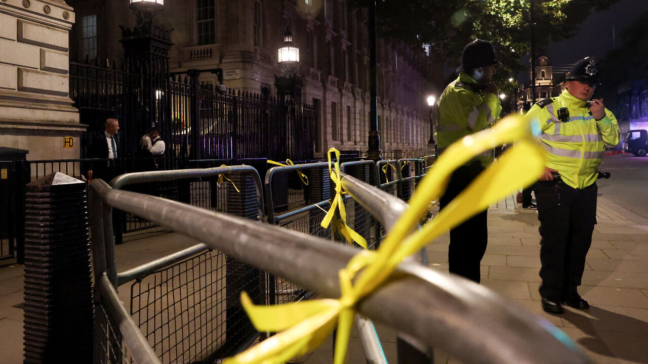 FILE PHOTO: Yellow ribbons hang on security railings outside Downing Street, placed by supporters of Campaign Against Antisemitism to remember the hostages still being held by Hamas as demonstrators gather outside Downing Street to demand stronger government action against antisemitism, one week after the deadly Manchester synagogue attack, in London, Britain, October 9, 2025. REUTERS/Toby Melville/File Photo
