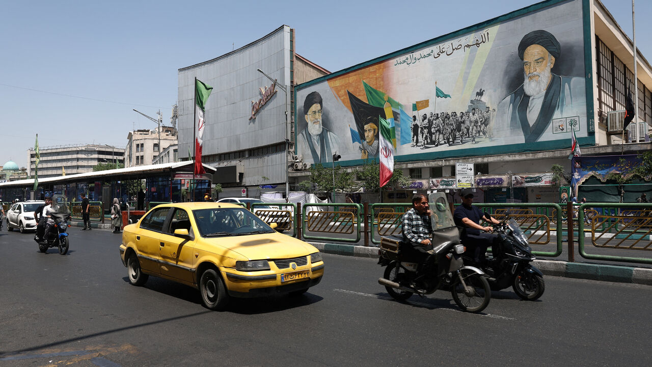 People ride past a mural depicting the late leader of the Islamic Revolution, Ayatollah Ruhollah Khomeini, and the late Iran's Supreme Leader Ayatollah Ali Khamenei, on a street in Tehran, Iran, June 9, 2026. Majid Asgaripour/WANA (West Asia News Agency) via REUTERS