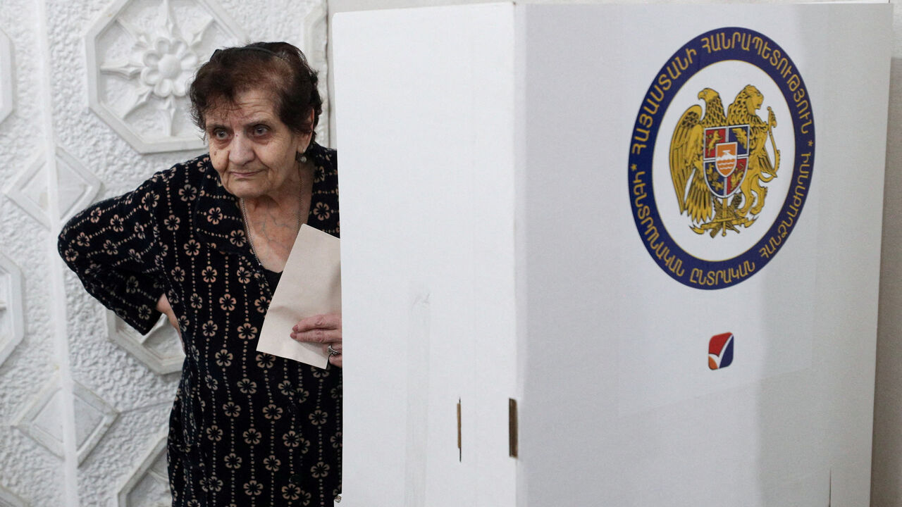 FILE PHOTO: A voter holds a ballot at a polling station during a parliamentary election in Yerevan, Armenia, June 7, 2026. Vahram Baghdasaryan/Photolure via REUTERS ATTENTION EDITORS - THIS IMAGE HAS BEEN SUPPLIED BY A THIRD PARTY./File Photo