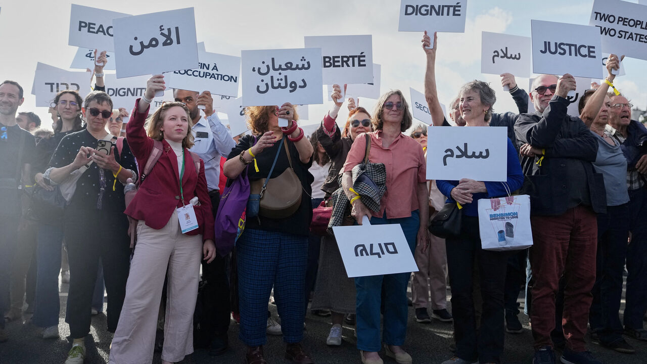 Participants in a conference with Israeli and Palestinian civil society groups supporting a two-state solution gather with placards on a bridge in support of a Palestinian state, in Paris, France, June 12, 2026. Thibault Camus/Pool via REUTERS
