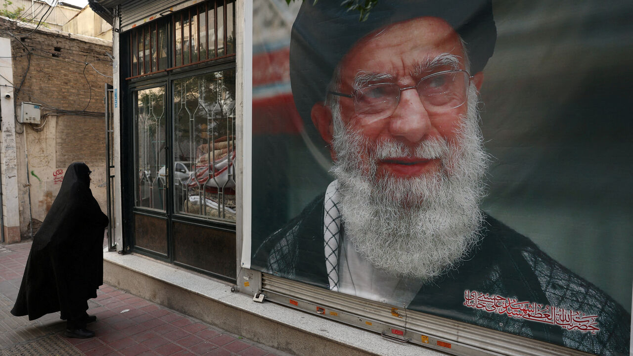 FILE PHOTO: A woman walks past a banner with a picture of the late Iran's Supreme Leader Ayatollah Ali Khamenei, on a street in Tehran, Iran June 7, 2026. Majid Asgaripour/WANA (West Asia News Agency) via REUTERS/File Photo