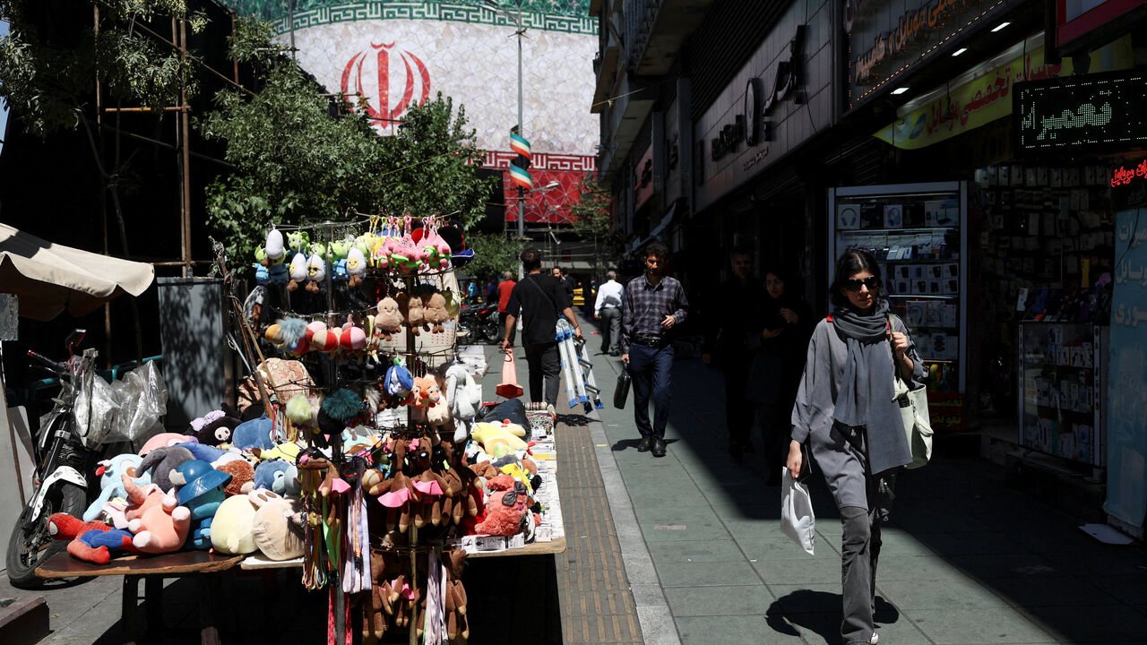 An Iranian woman walks on a street, after U.S. and Iranian officials said they had reached a deal to end their war and reopen the Strait of Hormuz, in Tehran, Iran, June 15, 2026. Majid Asgaripour/WANA (West Asia News Agency) via REUTERS