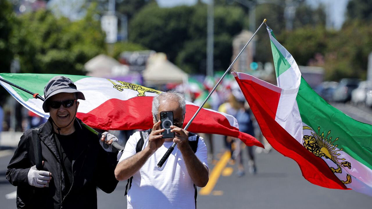 Soccer Football - FIFA World Cup 2026 - Group G - Iran v New Zealand - Los Angeles Stadium, Inglewood, California, U.S. - June 15, 2026 Protesters with Iran flags outside the stadium before the match REUTERS/Mike Blake