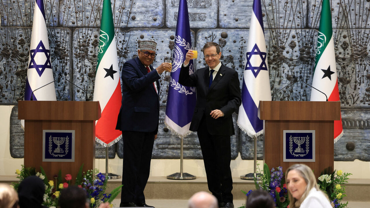 FILE PHOTO: Israel's President Isaac Herzog and Somaliland's President Abdirahman Mohamed Abdullahi hold up glasses of beverage before giving statements to the press at the President's Residence in Jerusalem, June 14, 2026. REUTERS/Ronen Zvulun/File Photo