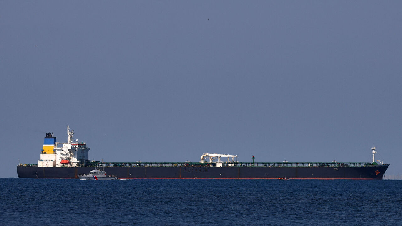 FILE PHOTO: A French Maritime Gendarmerie boat patrols around the Mozambique-flagged oil tanker named Deyna, which France says is part of Russia's shadow fleet, off the port of Marseille-Fos in the Gulf of Fos-sur-Mer, near Martigues, France, March 23, 2026. REUTERS/Manon Cruz/File Photo