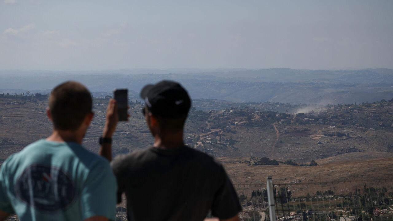People look at smoke rising in southern Lebanon, as seen from the Israeli side of the Israel-Lebanon border, in northern Israel, June 17, 2026. REUTERS/Shir Torem