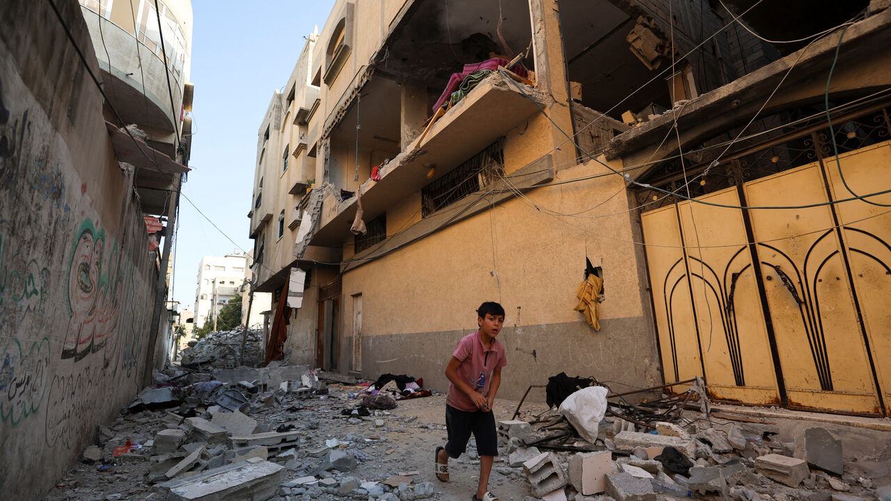 A Palestinian boy runs past the site of an Israeli strike on an apartment in Gaza City, June 20, 2026. REUTERS/Dawoud Abu Alkas
