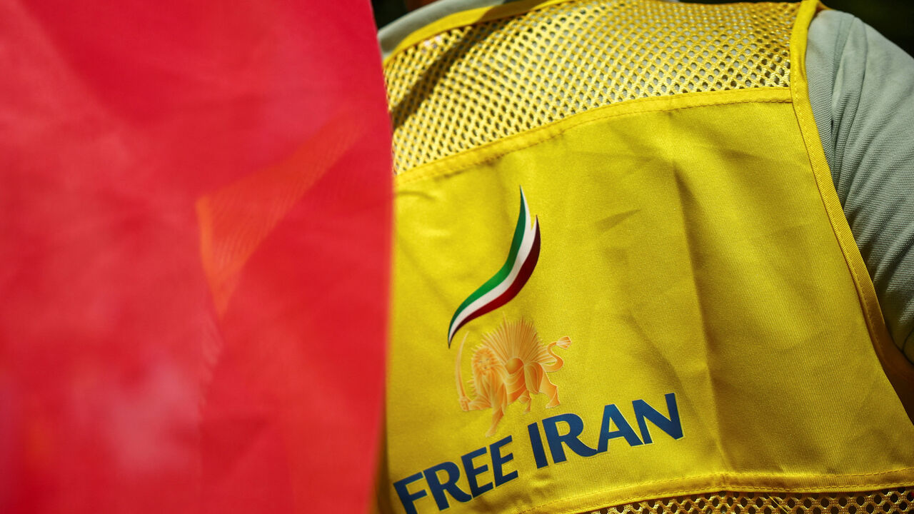 A man wears a jacket reading "Free Iran" and with a pre-Iranian Revolution "Lion and Sun" national emblem during a demonstration against political executions in Iran and in support of a democratic republic, a demonstration which was banned by Paris Police Prefecture, in Paris, France, June 20, 2026. REUTERS/Sarah Meyssonnier