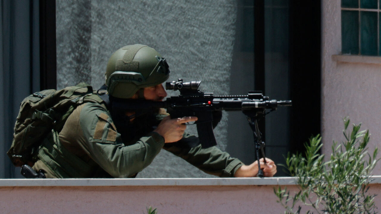 An Israeli soldier looks through the sight of his rifle, at his position near the border with Lebanon, in northern Israel, May 31, 2026. REUTERS/Amir Cohen