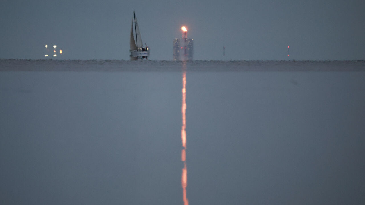 A yacht sails past a gas flare at Portovaya Bay on the coast of the Gulf of Finland in the Leningrad Region, Russia August 26, 2022. REUTERS/Stringer