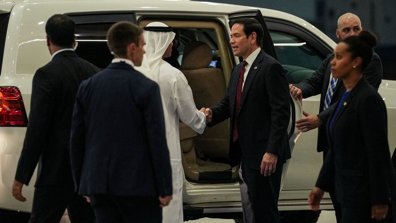 UAE Ambassador to the U.S. Yousef Al Otaiba shakes hands with U.S. Secretary of State Marco Rubio upon his arrival at Al Bateen Executive Airport to discuss the interim deal between the U.S. and Iran with Arab Gulf allies, in Abu Dhabi, United Arab Emirates, June 23, 2026. REUTERS/Eric Lee/Pool