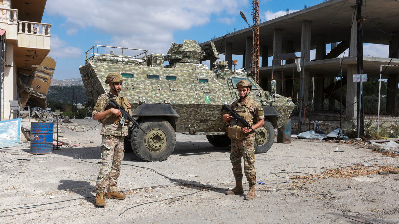 Members of the Lebanese army stand guard next to an armoured personnel carrier, as people make their way back to their homes, following a peace deal between the United States and Iran, in Bir Al-Salasil, Tyre district, southern Lebanon, June 15, 2026. REUTERS/Aziz Taher