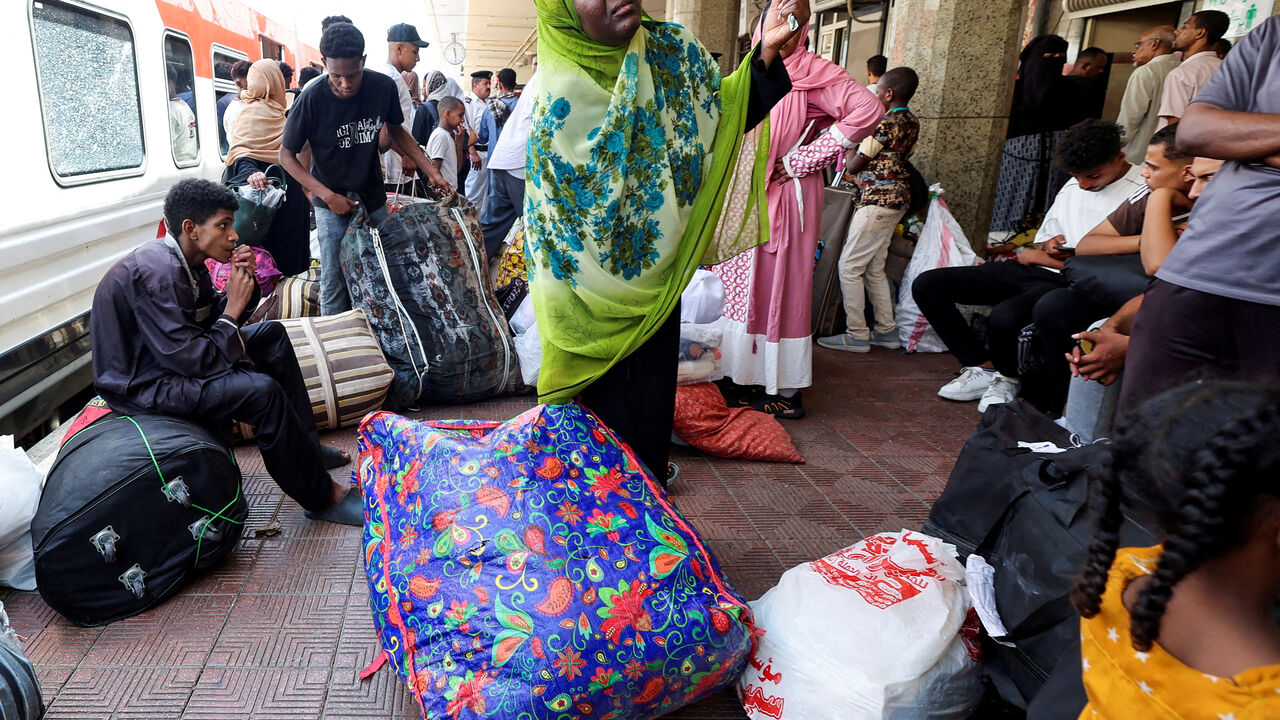 FILE PHOTO: People gather at a train station, as Sudanese refugees crowd at Cairo?s main station to board a free train with a voluntary return coordinated by the Egyptian government to Aswan, where buses will take them home to Khartoum, in Cairo, Egypt July 28, 2025. REUTERS/Amr Abdallah Dalsh/File Photo