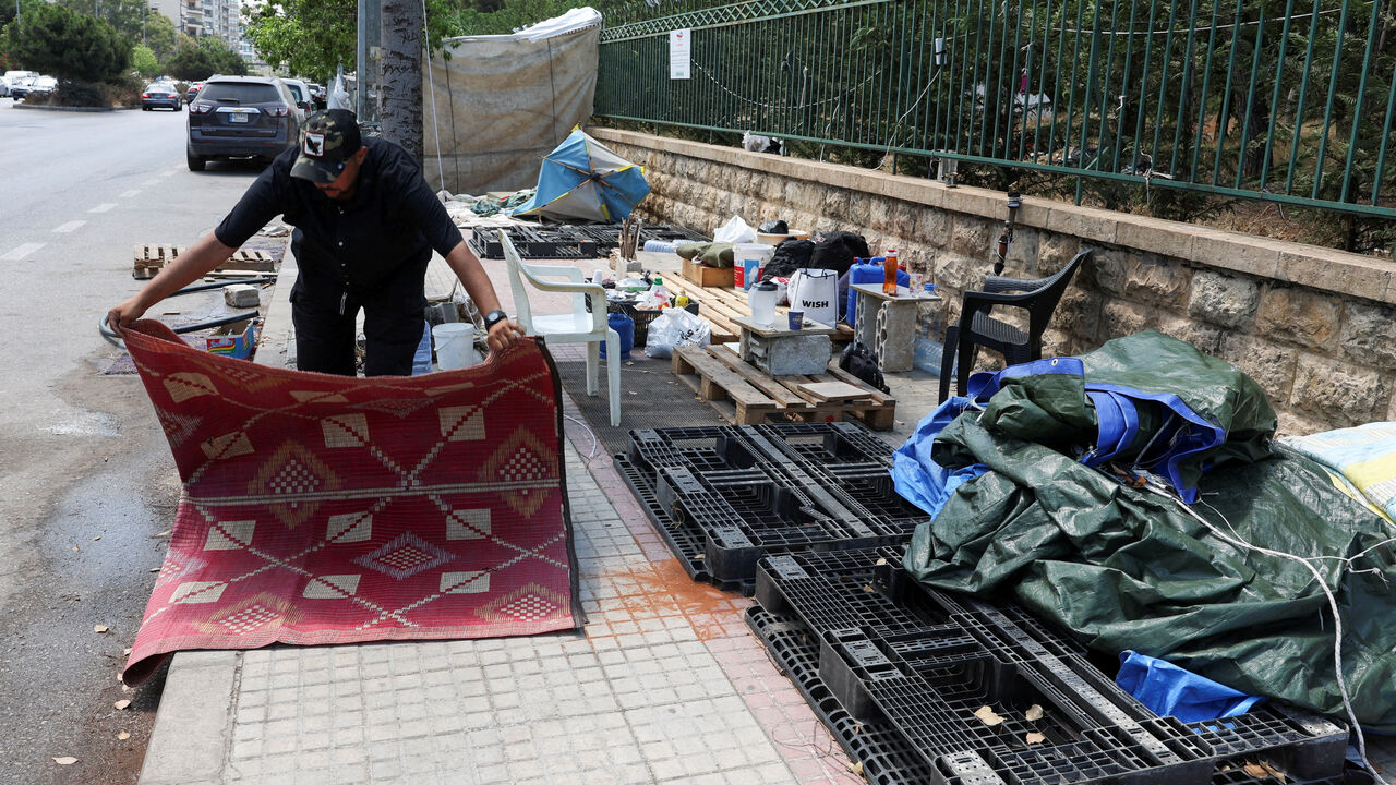 FILE PHOTO: Alaa Kobeissy packs his belongings on a sidewalk in Beirut, where he and his family have been living in a tent, as he prepares to return home following an interim deal between the U.S. and Iran, in Beirut, Lebanon, June 24, 2026. REUTERS/Mohamed Azakir/File Photo