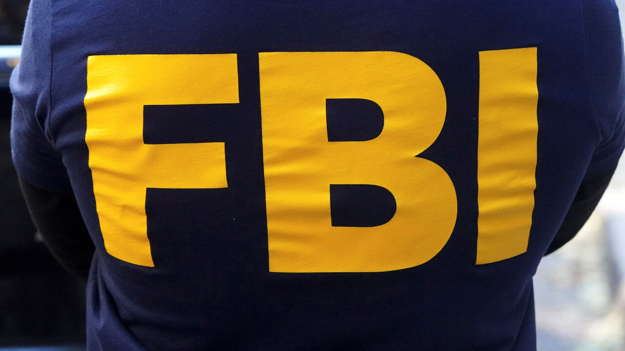 FILE PHOTO: An FBI logo is pictured on an agent's shirt in the Manhattan borough of New York City, New York, U.S. October 19, 2021. REUTERS/Carlo Allegri/File Photo