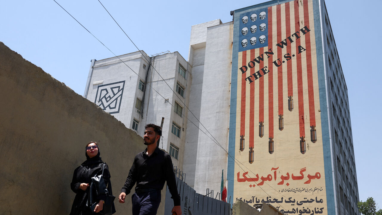 People walk near an anti-U.S. mural in Tehran, Iran, June 28, 2026. Majid Asgaripour/WANA (West Asia News Agency) via REUTERS