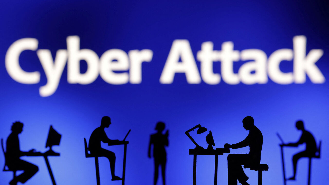 Figurines with computers and smartphones are seen in front of the words "Cyber Attack" in this illustration taken, February 19, 2024. REUTERS/Dado Ruvic/Illustration