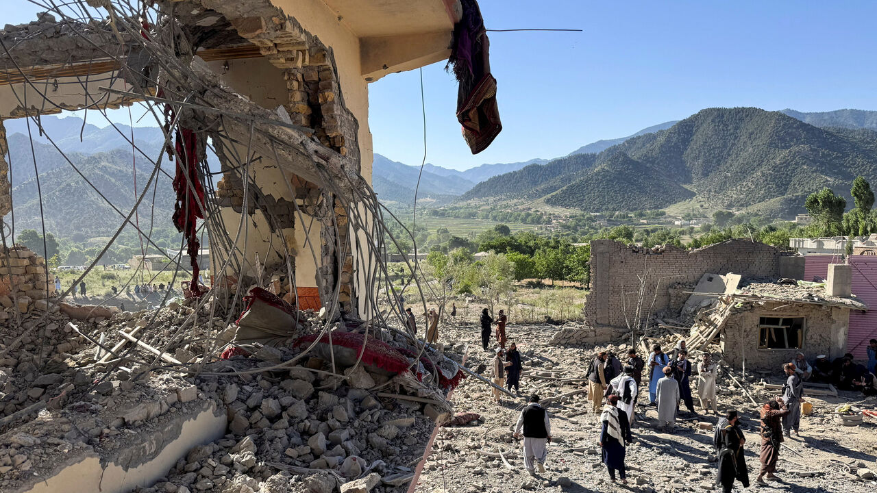 People gather near a destroyed building after an attack, which the Taliban say was an airstrike carried out by Pakistan's security forces, in Samkani District, Paktia Province, Afghanistan, June 29, 2026. REUTERS/Stringer