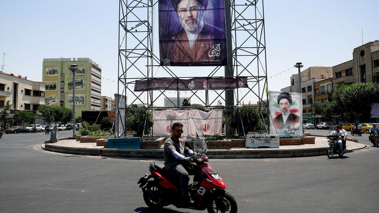 People ride past a banner with a picture of Iran's Supreme Leader, Mojtaba Khamenei, in Tehran, Iran, June 28, 2026. Majid Asgaripour/WANA (West Asia News Agency) via REUTERS
